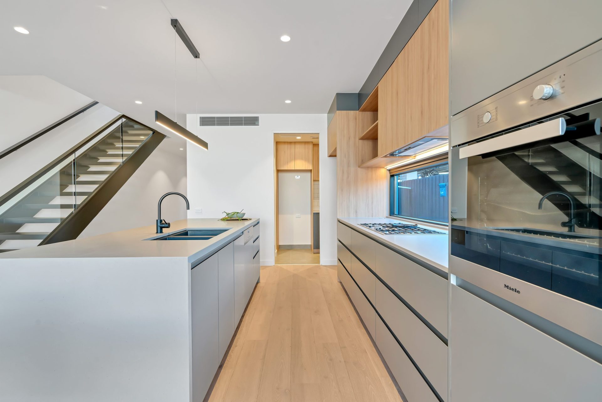 Modern kitchen in a combination of wood, white and gray laminate